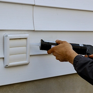 man gluing a vent